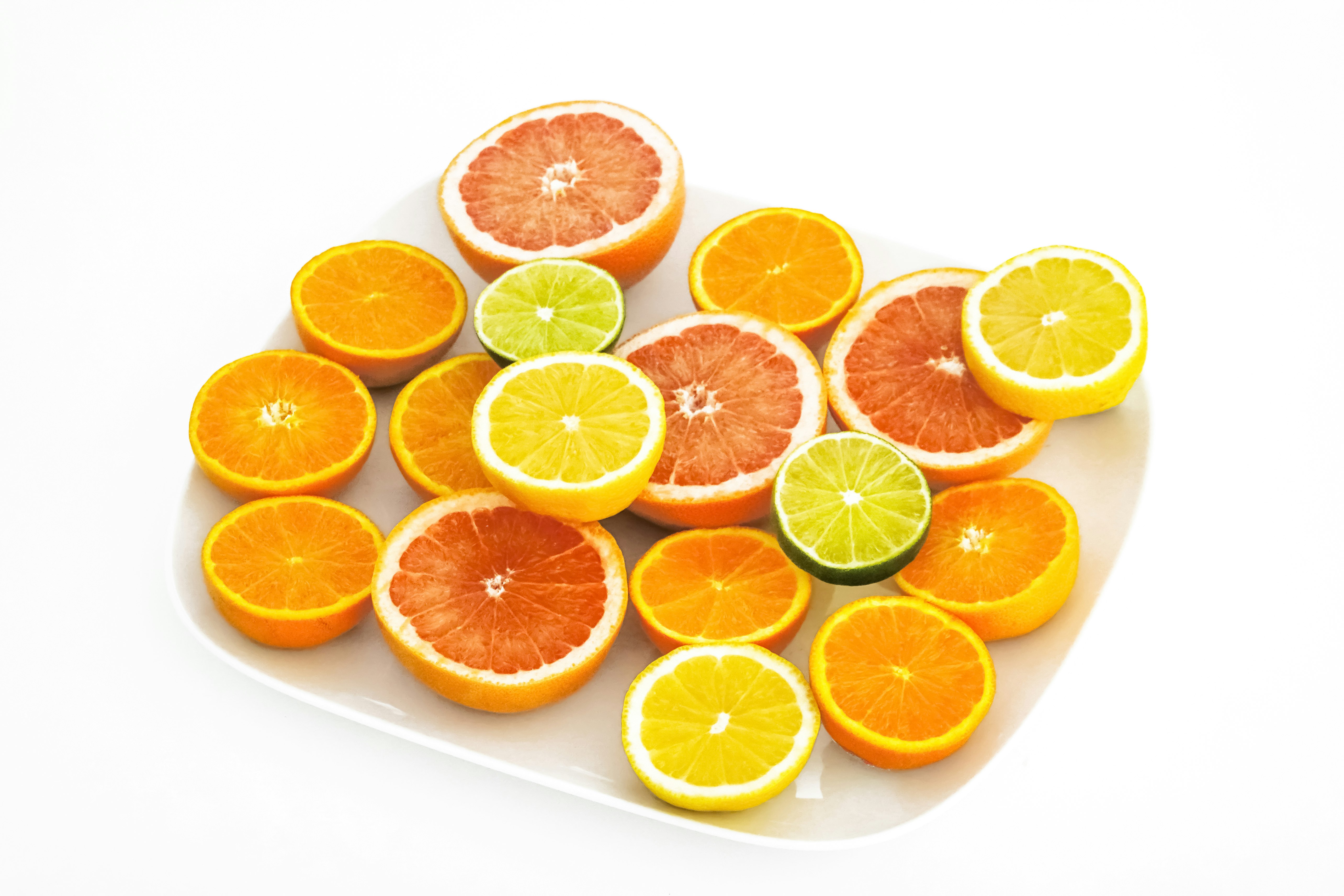 sliced orange fruit on white surface